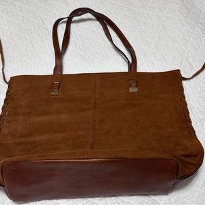 Suede on one side, leather look on the other.